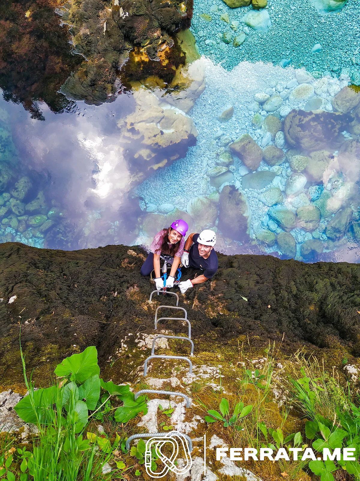 Two climbers at the top of a short ladder, with the sky reflected in the water below.